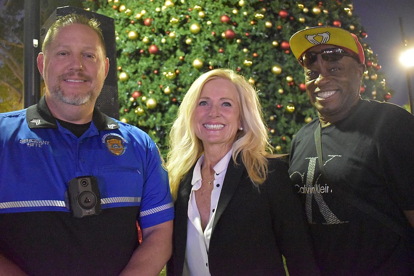 Sgt. Riffe, Kate Haris and Devron Minion join the St. Armands crowd for the tree lighting