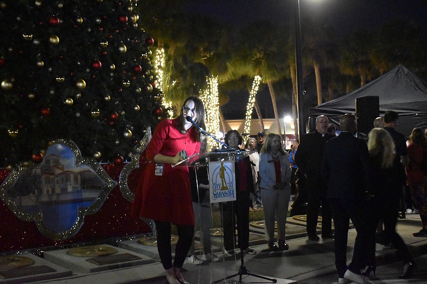 City of Sarasota Marketing and Outreach Coordinator Ciera Coleman welcomes the crowd to the 43rd year of the St. Armands tree lighting.