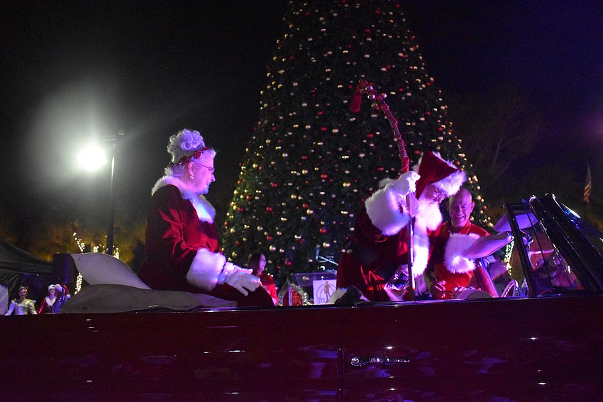 Mrs. and Mr. Claus make their stylish arrival in a vintage Mercedes.