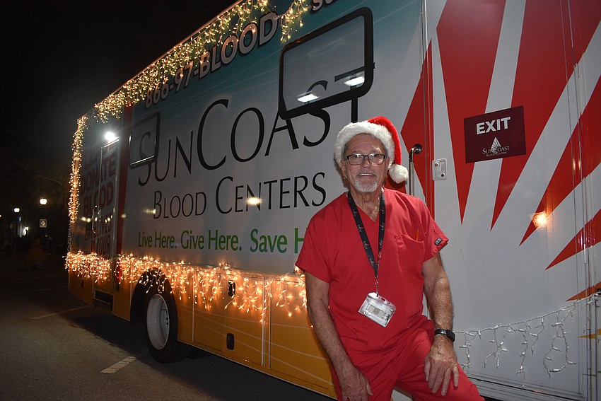 Fran Fougere drives the SunCoast blood donation bus at Sarasota's Holiday Parade.