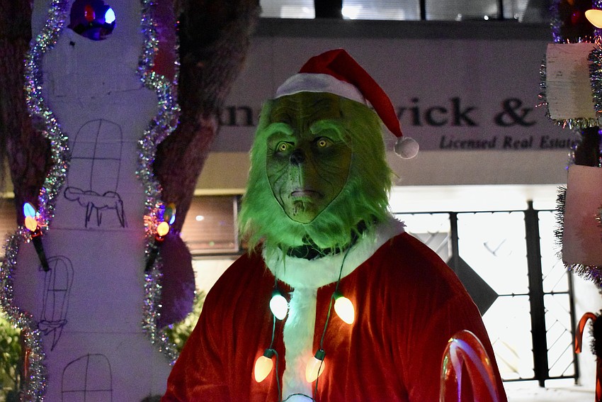 The Grinch contemplating whether to steal Christmas or not.