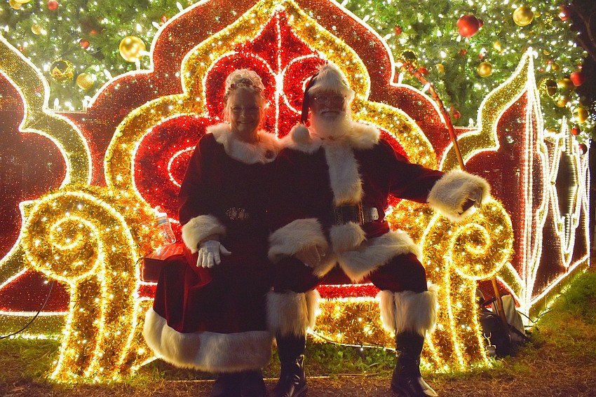 Mrs. and Mr. Claus sit in front of St. Armands 60 foot Christmas tree ready to take pictures with the children.