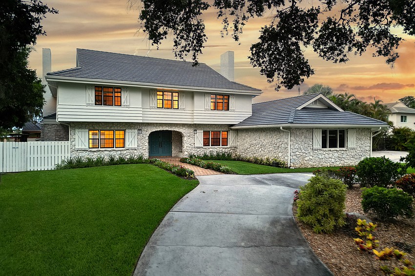 The driveway leads past the tennis courts and guest house on its way to the main house.