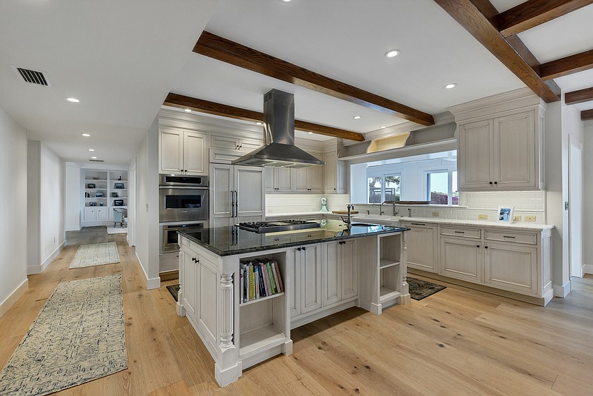 The kitchen island is equipped with a natural gas stove.