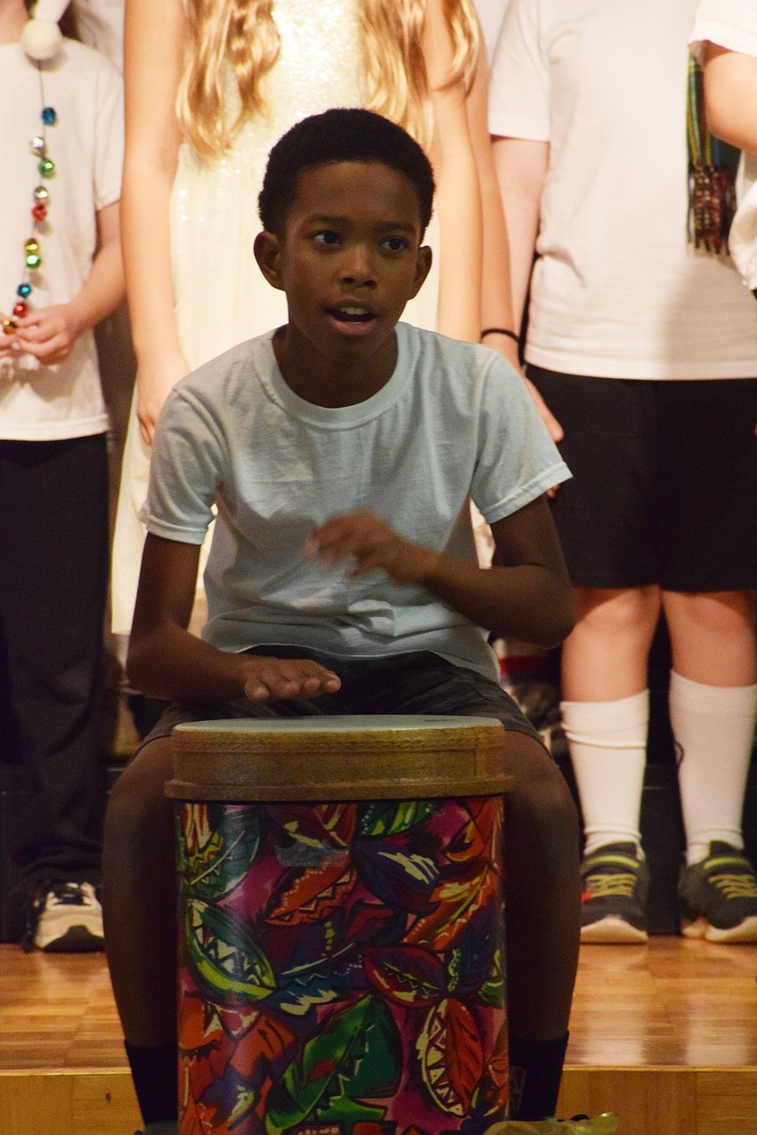 Jaylin Strong, a fifth grader, drums and sings along.