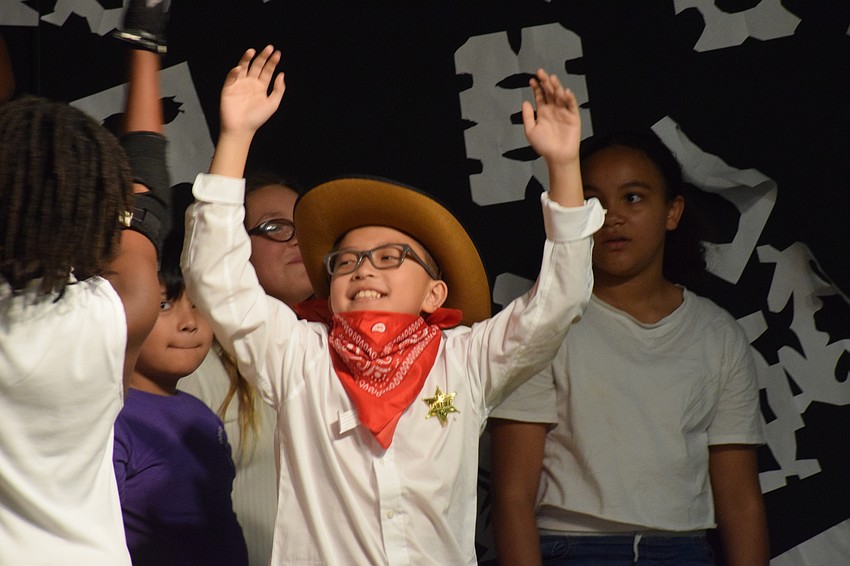 Nathan Pham, a fifth grader dressed as a cowboy snowman, celebrates the holiday season.