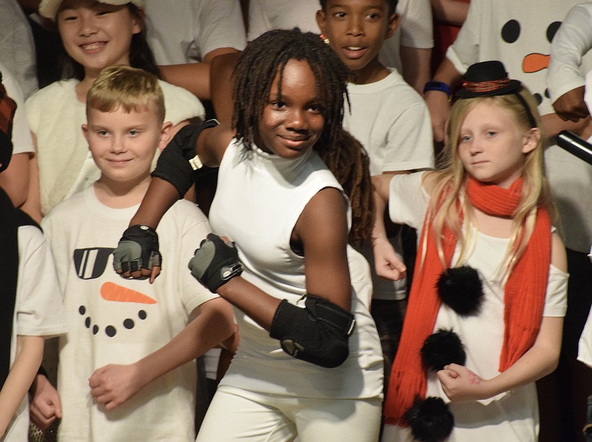 Fifth graders Connor Winchell, Kaylani Roney and Raylin Hagood strike a pose at the end of a song.