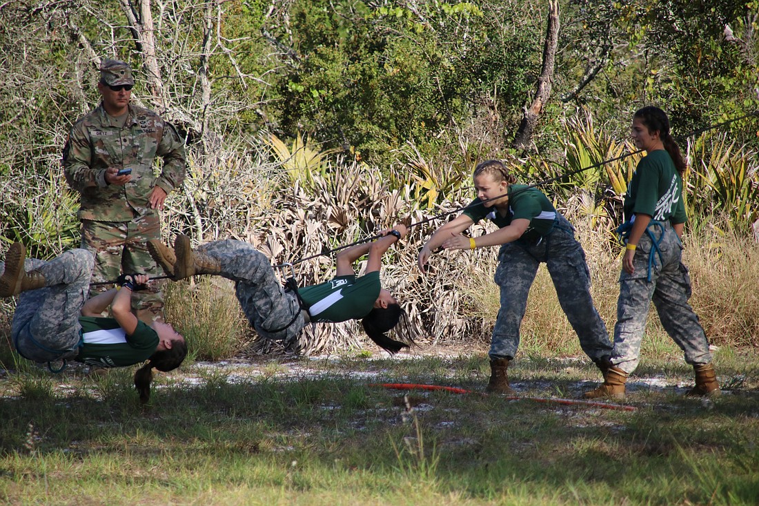 Lakewood Ranch High School's Audrey Weeks, Karen Tinoco, Skylar Cox and Samantha Rees compete in the rope bridge at the Raiders state championship. The team placed third.