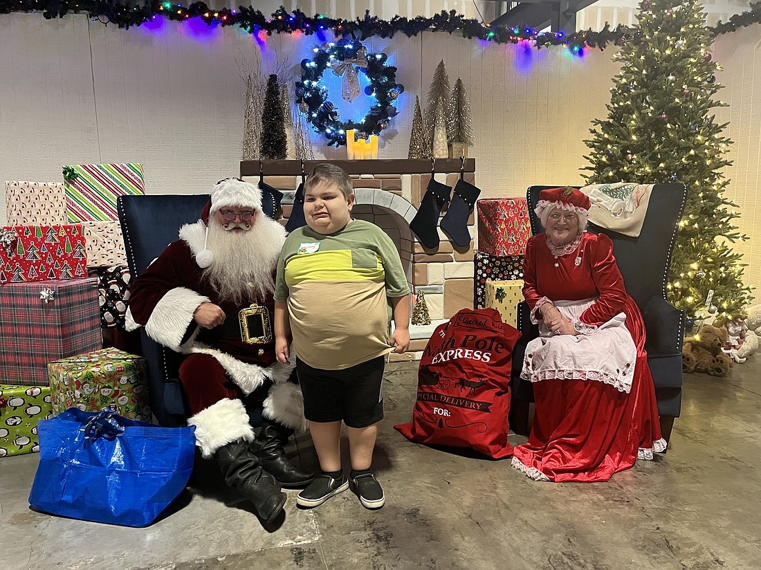 Myakka City's Larry Morris, who is 12, meets Santa and Mrs. Clause.