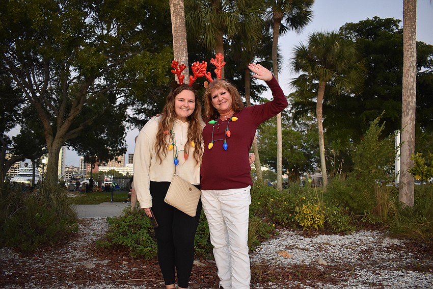 Nicole Melvin and Christa West claim a spot on Bayfront Park to watch the boat parade.