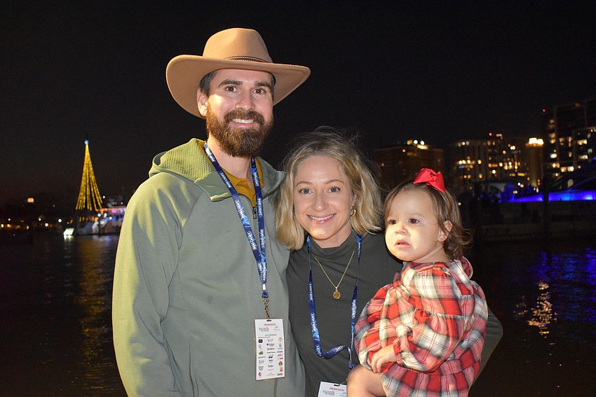 Logan, Laura and Willow watch the boat parade on the Marina dock.