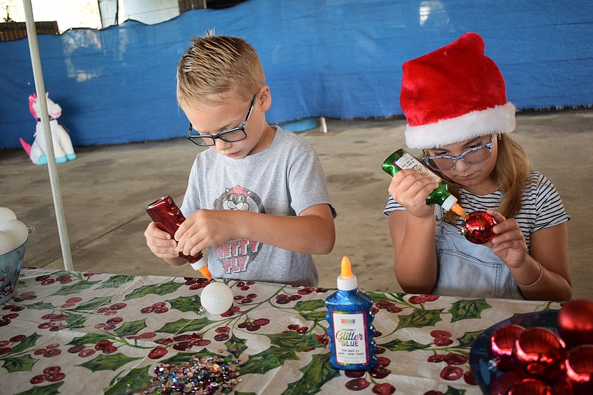 Creekwood's Ronin Reyes, 6, and Chloe Scott, 10, create Christmas ornaments at Herrmann's Royal Lipizzan Stallions.