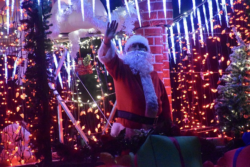 Santa dashes through the bay on his brightly decorated boat.