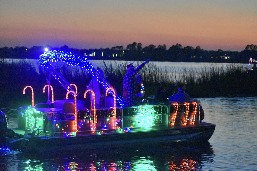 Sarasota's Don Traver waves to the crowd as he passes by Jiggs Landing.