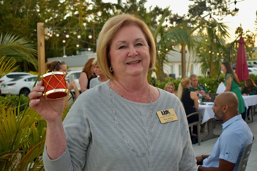Reva Jackson with Cadence Bank brings a drum ornament.