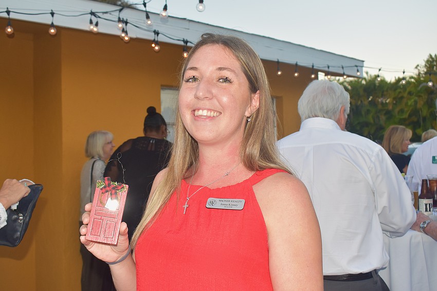 Jonna Kinney represents Wagner Realty with a red door ornament.