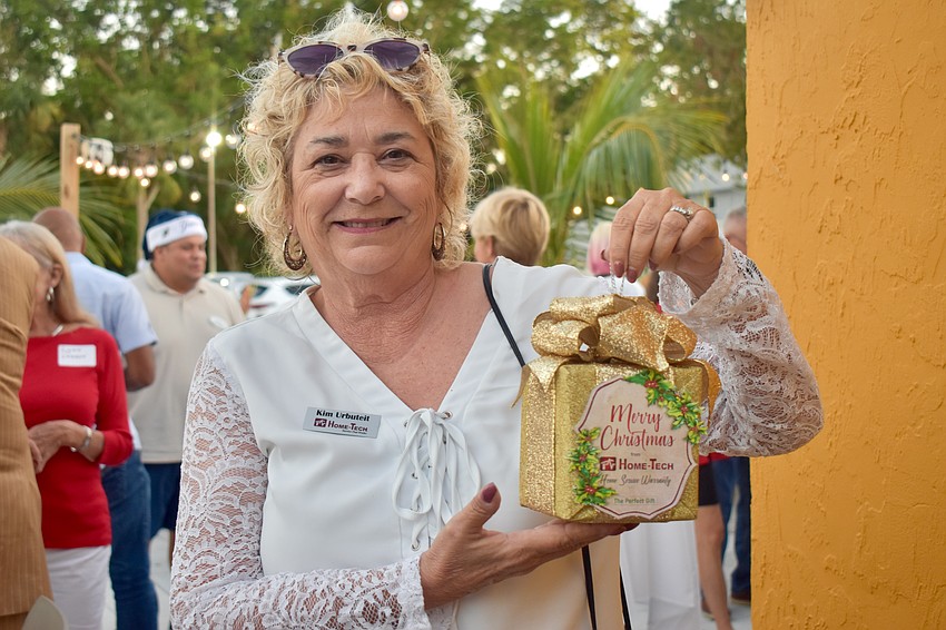 Kim Urbuteit with Home-Tech shows off her golden lock box ornament.