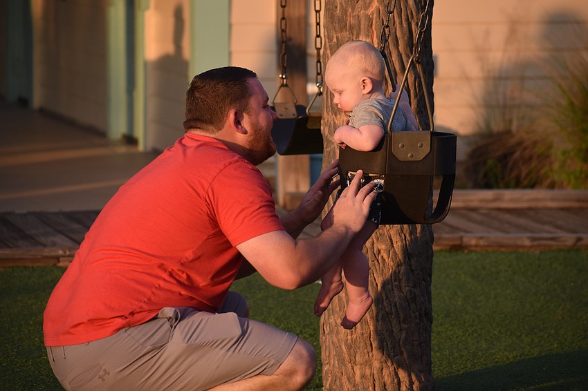 Creekwood's Kevin Dillingham entertains his 1-year-old son Jackson Dillingham at Jigg's Landing.