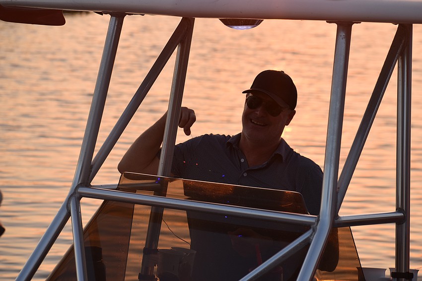 East County's Gris Bettle hangs a strand of lights on his family's boat.