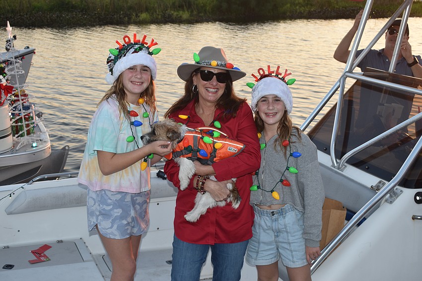 East County's 10-year-old Genevieve Bettle, her aunt, Myakka City's Patricia McKeithen, her twin sister Daphne Bettle, and her family's dog Freddie prepare for the parade.