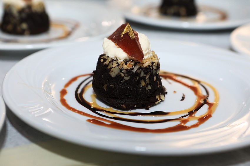 Guests receive chocolate cake topped with whipped cream and pickled pear.