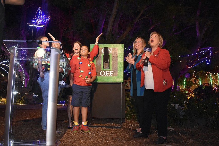 Oliver Elliott, Keely Ramsdell, Kirsten Russell, Xavier Lawson, Jennifer Rominiecki and Linda Carson flip the switch.