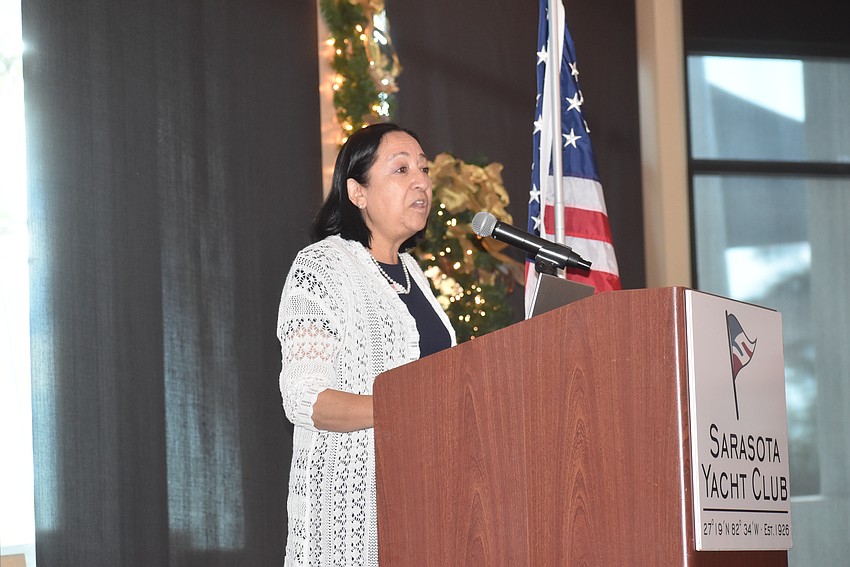 Recently retired UnidosNow Executive Director Luz Corcuera greets the Longboat Key Democratic Club members.