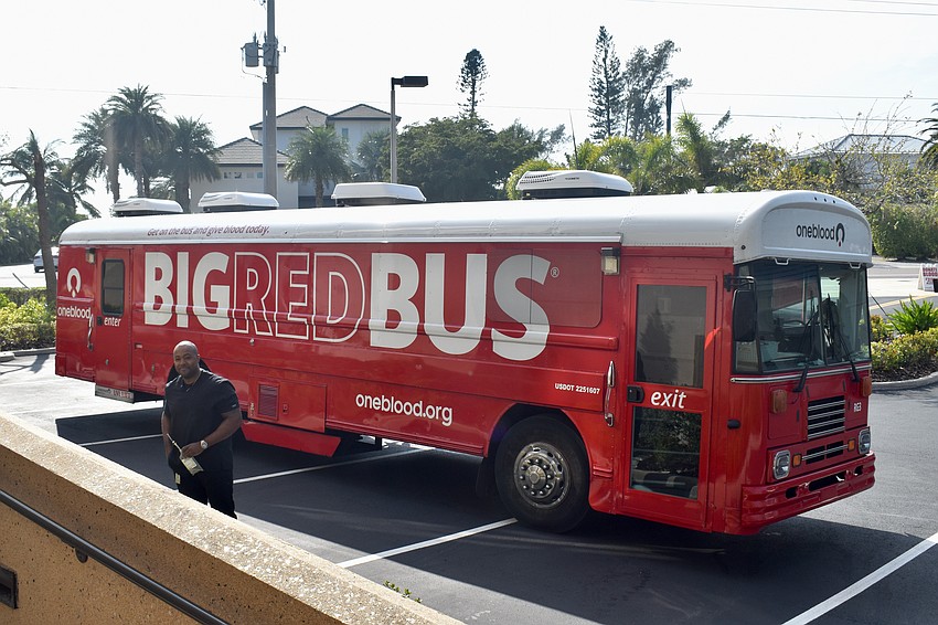 Byron Kennedy taking blood donations on the Big Red Bus parked in the church's lot on seed packing day.