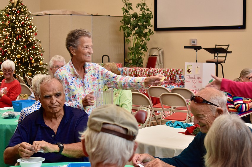 Sue Wertman passes the winning raffle ticket to her sister.