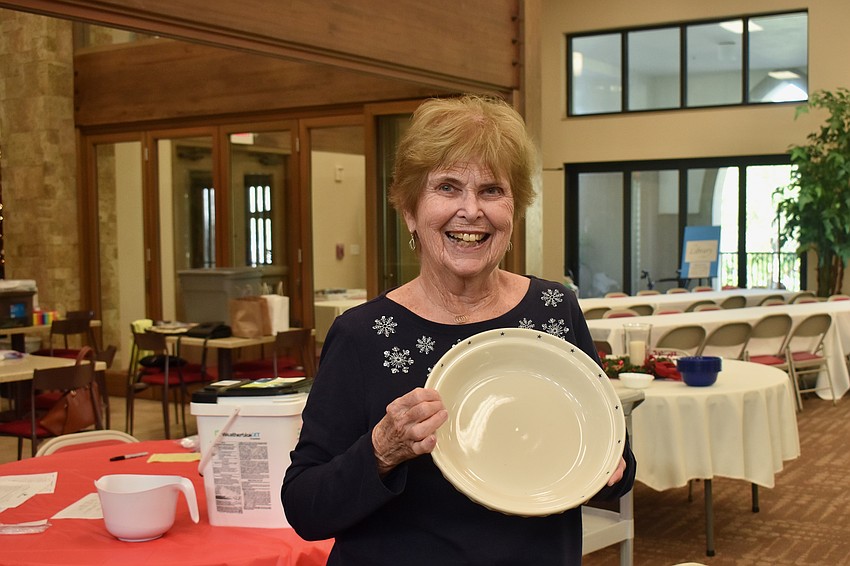 Carole McLaughlin wins the first raffle and gets the first pick of prizes.