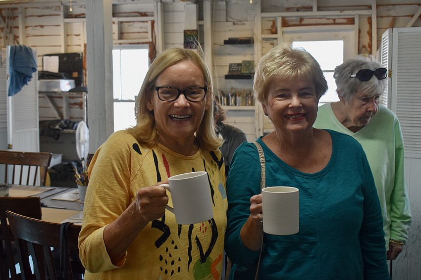 Michelle Giannico and Jamie Engel choose mugs to paint.