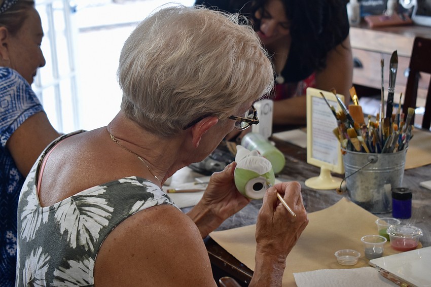 Ginger Stefan paints a gnome.