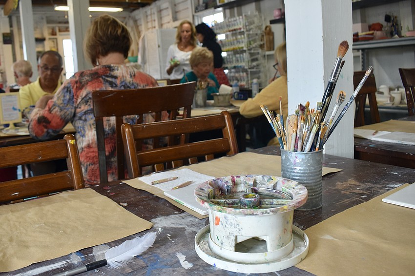 Members of the Longboat Island Chapel paint the afternoon away at the Artful Giraffe.