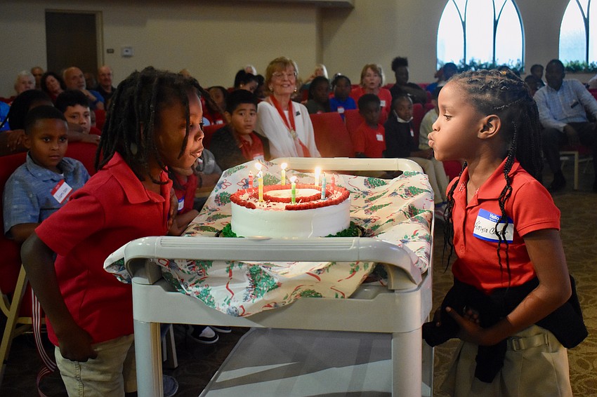 Jayceon Johnson and Amyla Carter blow out the candles.