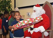 Peyton Washington happily accepts his gift from Santa.