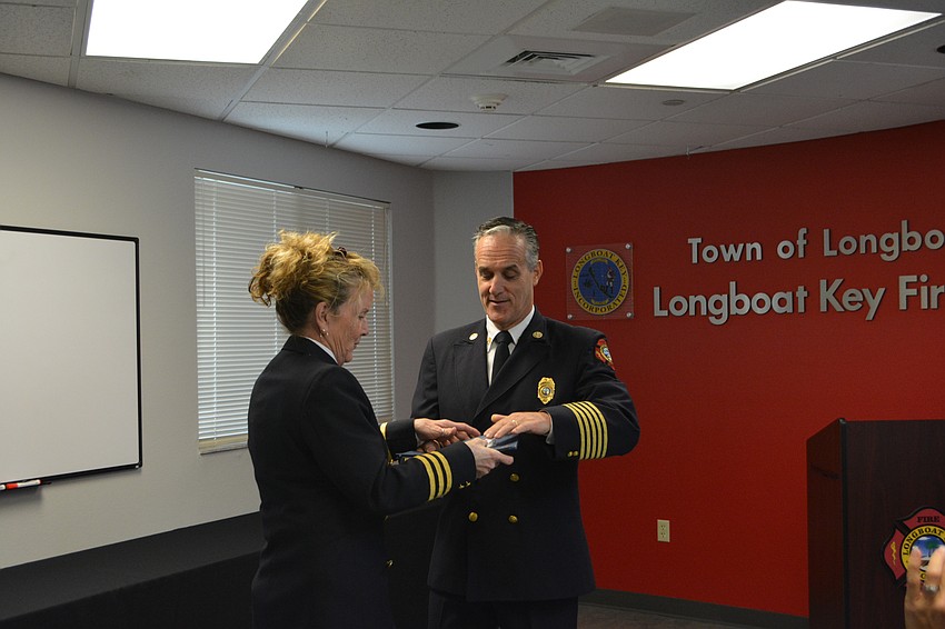 Fire Marshal Jane Herrin, left, receives an award for her above and beyond service to the department.