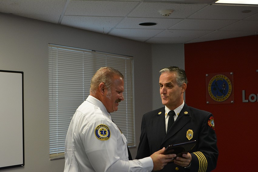 Lt. Ron Koper, left, receives the departments's 2022 Employee of the Year award.