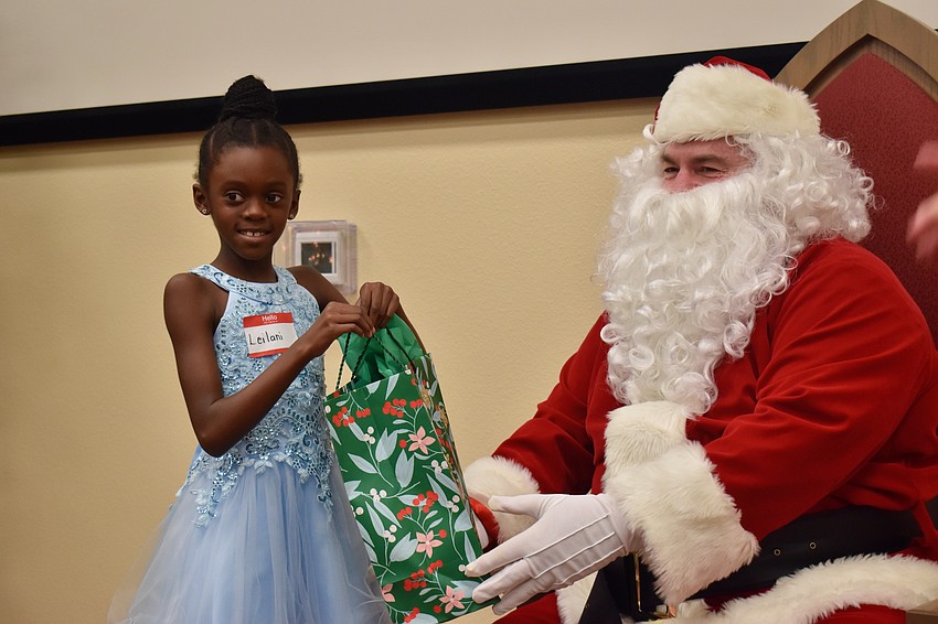 Leilani Bell receives a gift from Santa.
