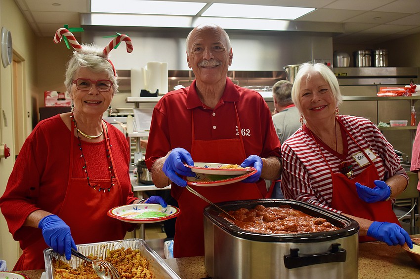 Joan Pritchard, Bob Dods and Barbara Grimes on kitchen duty.