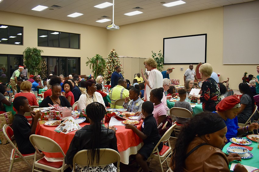 About 50 children and their families eat dinner at Christ Church on Wednesday night.