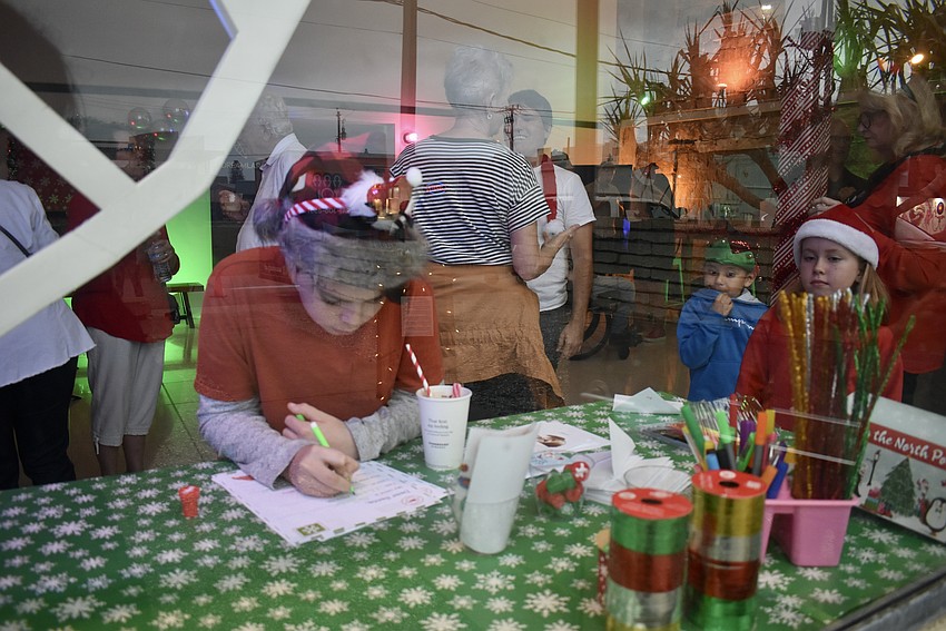 Balthazar O'Neil, Celeste O'Neil and Jesus Resendiz stop by the Letters to Santa station.