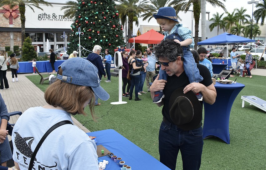 Lakewood Ranch's Libby Lurie, of Temple Emanu-El, greets Sarasota's Justin Bloom and 2-year-old Miles Bloom.