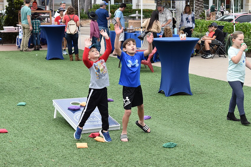 Lakewood Ranch 6-year-old Colton Zukas and 8-year-old Matthew Dobson try to be the first to catch a beanbag flying their way.