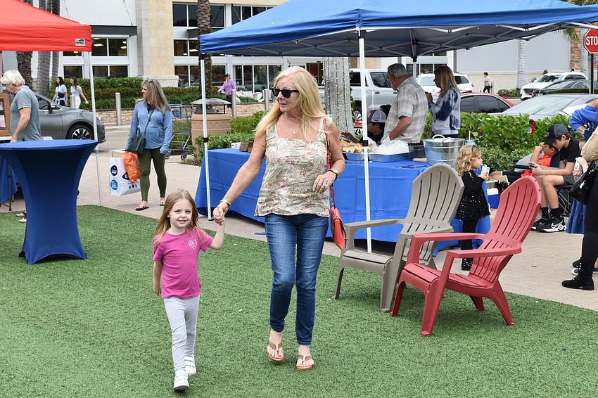 North Port 3-year-old Allaini Parmenter strolls through the event with her grandmother, Palm Aire's Charlotte Emerson.