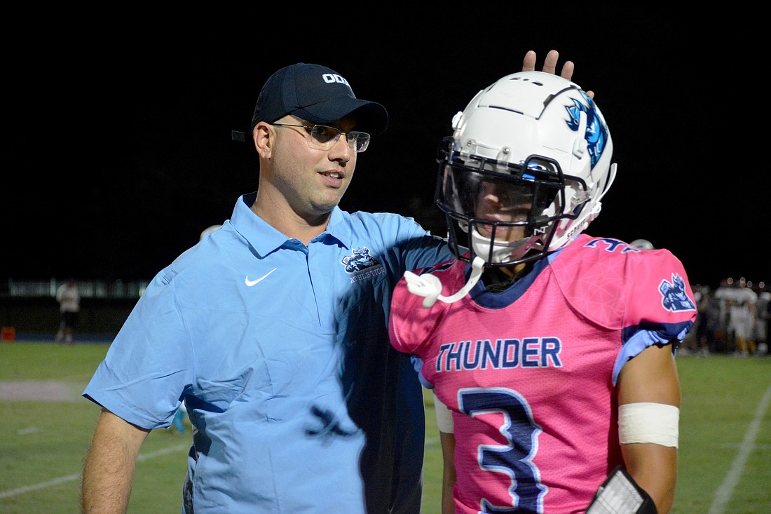 ODA Coach Rob Hollway pats Michael Luedeke on the head. Hollway led the Thunder to a 9-1 record in 2022.