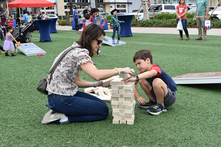 Lakewood Ranch's Elana Schwartz and 7-year-old Levi Schwartz prepare for a game of Jenga on The Green.