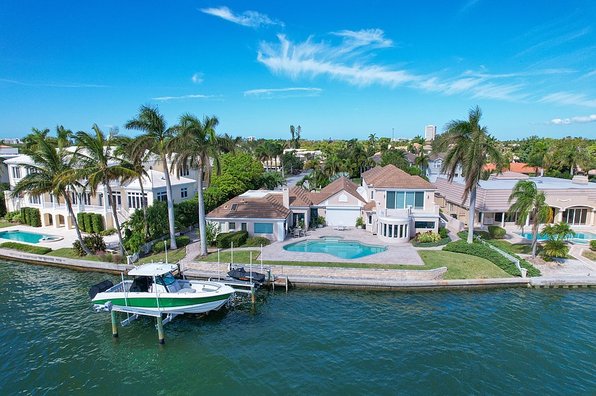 The home is along a deep water dock space, with a boat lift and personal watercraft lift.