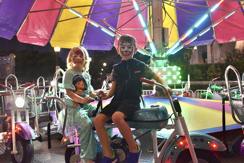 Grace and John Martin rides the motorcycle carousel.
