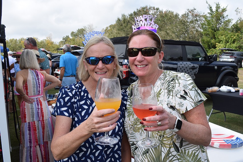 Karen Mannering and Deborah Rahman, both of Lakewood Ranch, toast a new year while enjoying polo on Jan. 1.