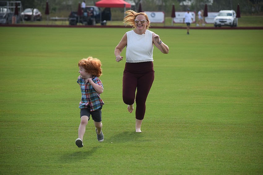 Before the horses take the playing field at the Sarasota Polo Club, fans are allowed to enjoy the field. Lakewood Ranch 4-year-old Caspian Reeves tries to outrun his mom, Ashley McLeod.